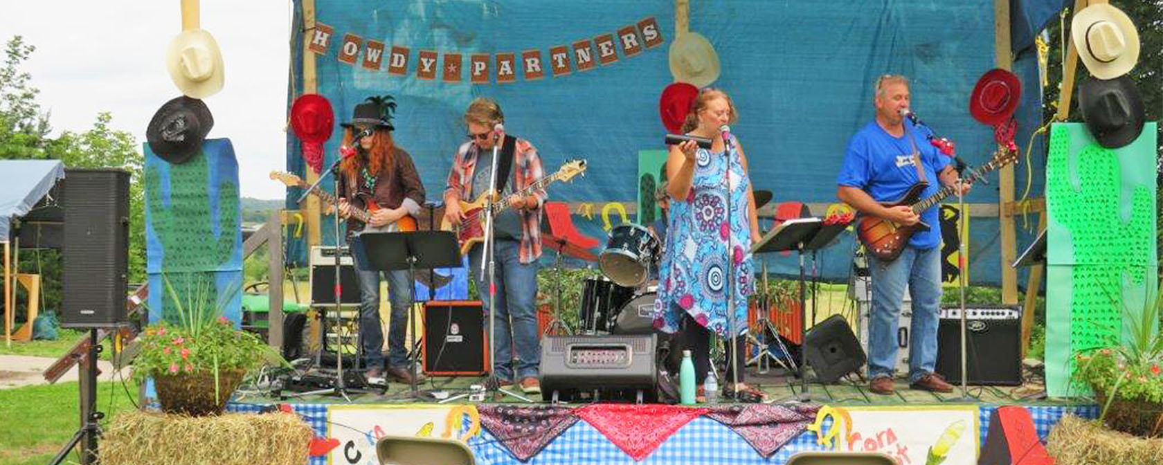 band members perform on a decorated stage