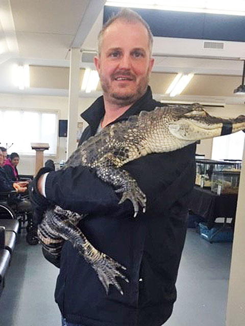 Man holding an alligator